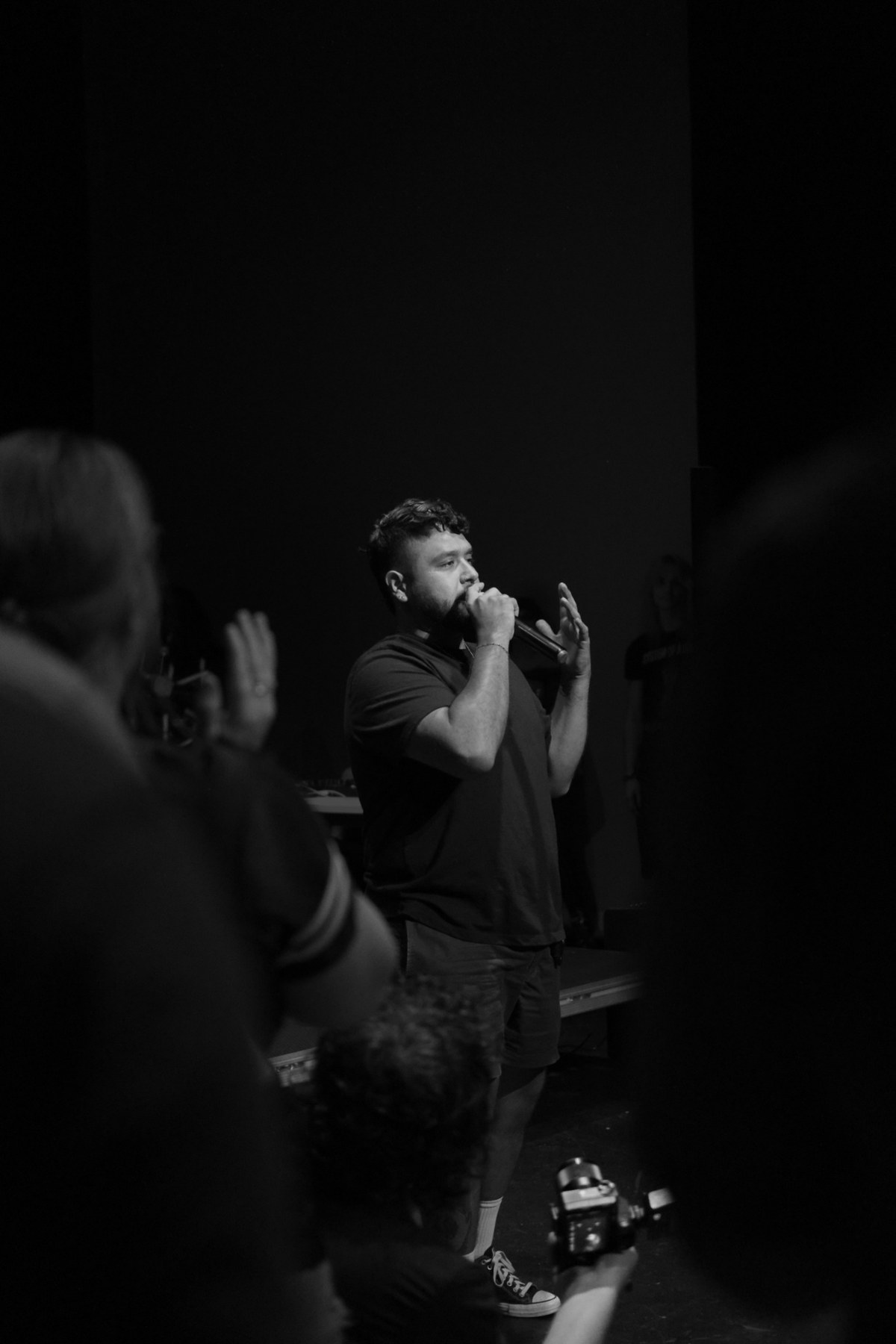 Armando speaking into a microphone